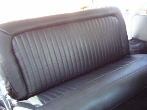 1978 Ford Bronco - Interior shot of a black vinyl bench seat with ribbed upholstery.