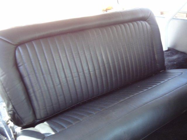 Black vinyl bench seat with vertical pleats, interior view