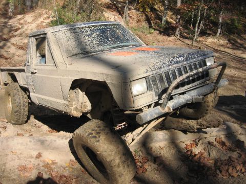 1987 Jeep Comanche - This 1987 Jeep Comanche is shown off-roading on a muddy, rocky trail.