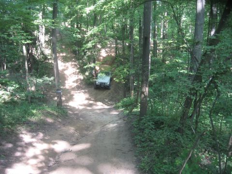 1987 Jeep Comanche - 1987 Jeep Comanche navigates a wooded trail.