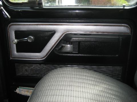 1979 Ford F-350 - Interior view of a 1979 Ford F-350 door panel, showing the handle and window crank.