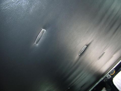 1979 Ford F-350 - The interior of a vehicle shows a black headliner with multiple clear plastic trim pieces.