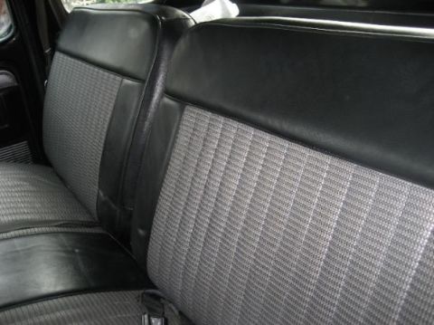 1979 Ford F-350 - Interior view of a 1979 Ford F-350, showing the bench seat with gray fabric and black vinyl accents.