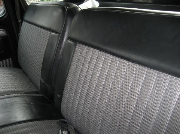 Gray patterned bench seat with black vinyl trim. 1979 Ford F-350 interior