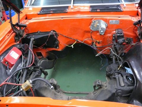 1968 Chevrolet Camaro - The engine bay of a 1968 Chevrolet Camaro is shown, with the engine removed and wiring exposed.