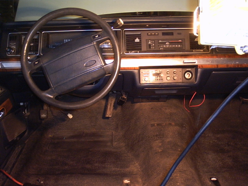 1991 Ford Crown Victoria interior dashboard with Ford steering wheel and wood trim