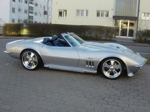 1976 Chevrolet Corvette - This silver convertible sports car features a distinctive Stingray badge and custom chrome wheels.