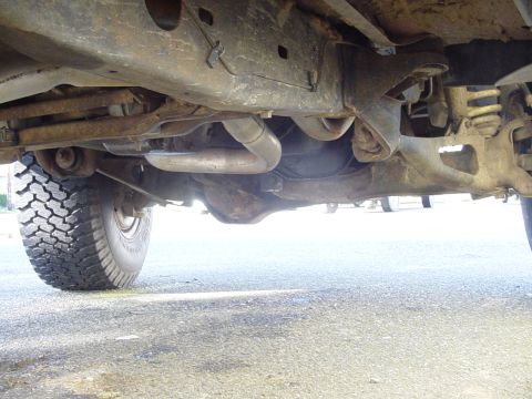 1987 Ford Bronco - Undercarriage of a 1987 Ford Bronco, focusing on the frame and suspension components.