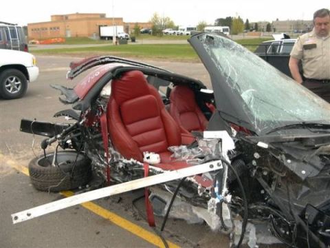 1976 Chevrolet Corvette - This severely damaged convertible sports car has its front end completely crushed and the windshield shattered.