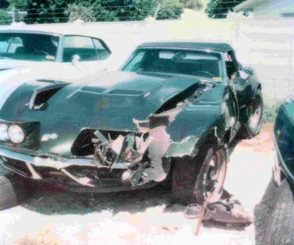Damaged dark green 1976 Chevrolet Corvette, front end destroyed