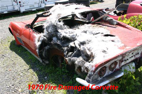 1976 Chevrolet Corvette - This red convertible shows severe fire damage, obscuring many details. The visible text indicates it is from 1970.
