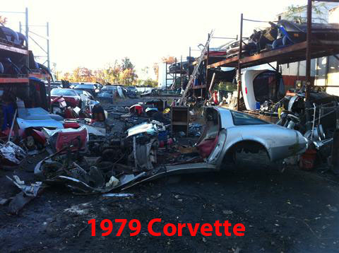 1976 Chevrolet Corvette - Junkyard scene with car parts and a silver vehicle body. Text indicates '1979 Corvette'.