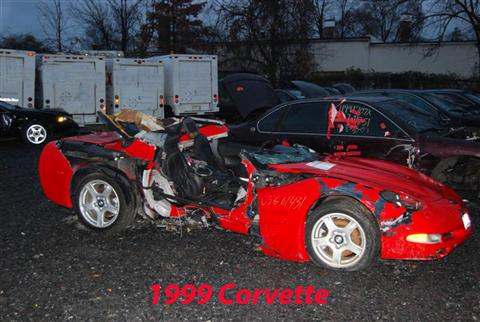 1976 Chevrolet Corvette - This heavily damaged red sports car appears to be a 1999 Corvette, not a 1976 model.