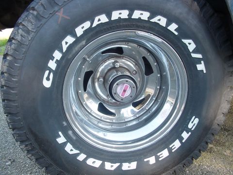 1987 Ford Bronco - A close-up view of a tire and wheel assembly, showing the tread and rim details.