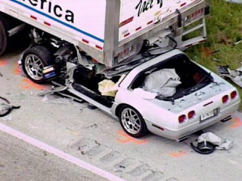 1976 Chevrolet Corvette - A silver sports car is severely damaged after colliding with the rear of a semi-trailer truck.