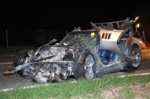 1976 Chevrolet Corvette - This heavily damaged silver sports car shows extensive front-end destruction and an open driver's side door.
