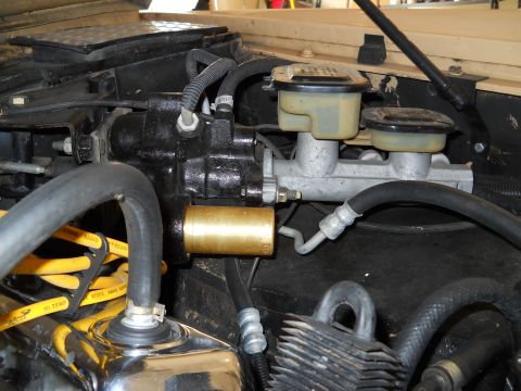 1976 Ford Bronco - Close-up view of the brake master cylinder assembly, dual reservoirs and a brass-colored component.