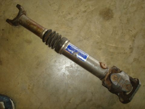 1995 Ford Bronco - Driveshaft with a blue label and rubber boot, likely a replacement part.