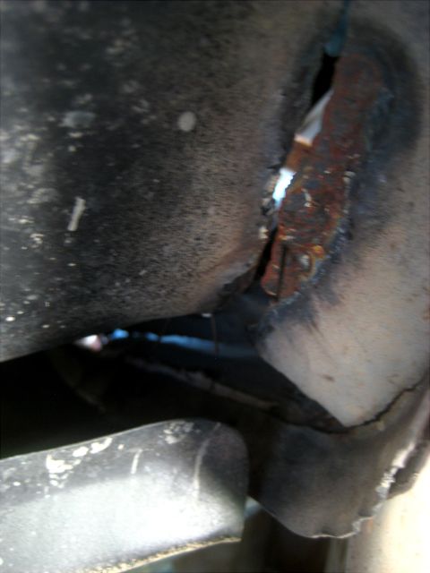 1996 Ford Bronco - The image shows significant rust and damage to a vehicle's frame, indicating structural compromise.