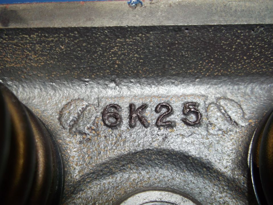Engine part with casting numbers 6K25 and a partial date stamp