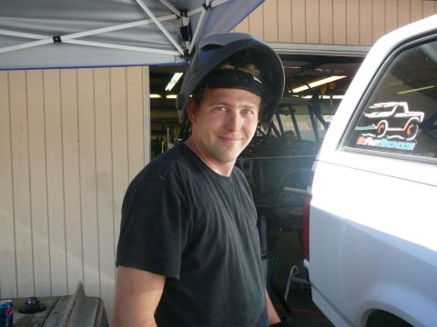 1988 Ford Bronco - A man in a welding mask stands next to a white vehicle, with a sticker on the window.