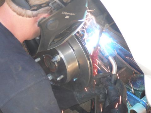 1988 Ford Bronco - A mechanic welds a brake rotor, indicating repair work on a vehicle's braking system.