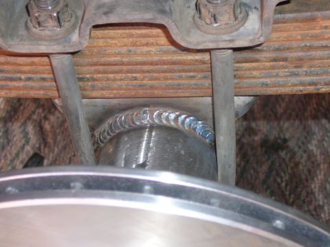 1988 Ford Bronco - Close-up view of a welded axle housing and leaf spring assembly, with visible SuperMotors.net branding.