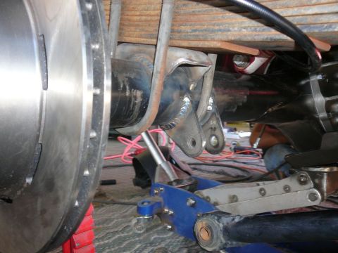 1988 Ford Bronco - This photo shows the underside of a vehicle, focusing on the rear axle, brake rotor, and suspension components.