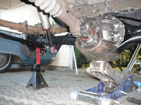 1988 Ford Bronco - Close-up view of a vehicle's rear axle and suspension system, showing components being worked on.