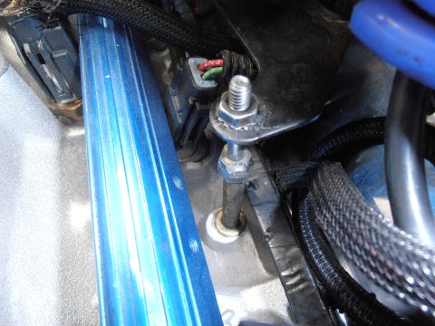 1990 Ford Bronco - Engine bay detail with a blue fuel rail and associated hardware.
