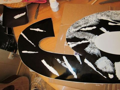1991 Ford LTD Crown Victoria - Guitar body undergoing custom paint work with black and white abstract design.