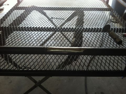 1993 Jeep Cherokee - A close-up view of a metal roof rack, showing its mesh construction and a section of a damaged bar.