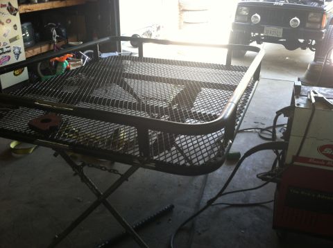1993 Jeep Cherokee - A custom roof rack is being fabricated and welded in a garage setting.