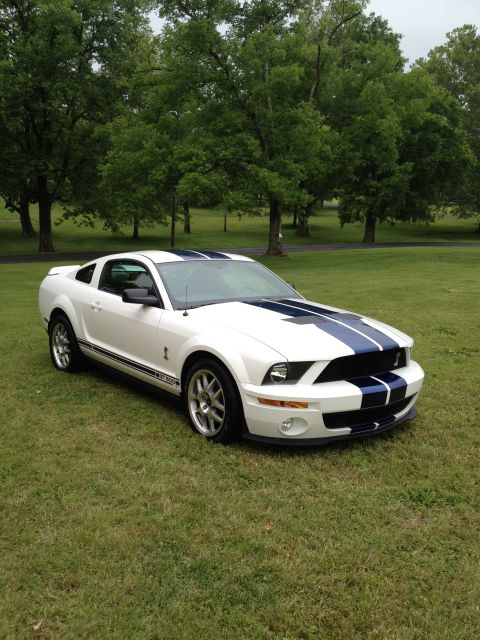 2007 Ford Mustang - White 2007 Ford Mustang Shelby GT500 with dual blue racing stripes and side stripe.