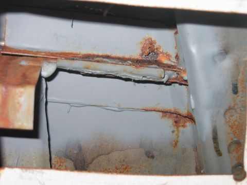 1992 Ford Bronco - Inside the access panel, looking at the back side of the rain gutter, passenger side.. You can see where all the rust has come through in t…