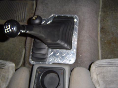 1989 Ford Ranger - Close-up of a manual transmission shifter and boot inside a vehicle.
