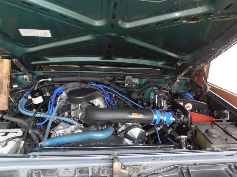 1990 Ford Bronco - Customized engine bay with performance upgrades, including a K&N air intake system.
