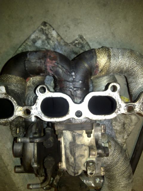 1995 Ford Probe - Close-up of a used turbocharger and exhaust manifold assembly.