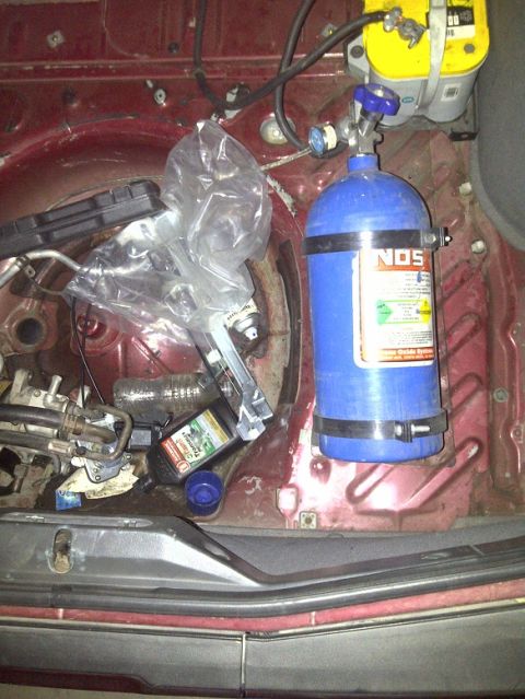 1995 Ford Probe - A blue NOS bottle and a yellow Optima battery are visible in the trunk of a vehicle.