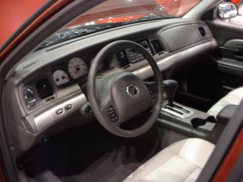 1999 Ford Crown Victoria - Dashboard and interior of a 2003 Mercury Grand Marquis, seen from the passenger side.