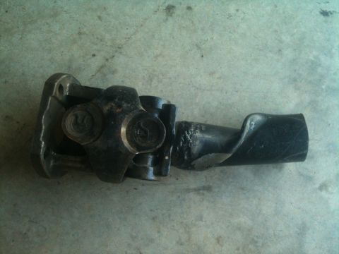 2000 Jeep Wrangler - A close-up view of a damaged driveshaft component, showing wear and deformation.