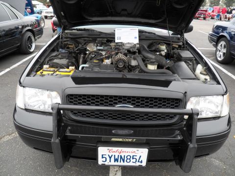 2003 Ford Crown Victoria - Black Crown Victoria with Code 3 push bar and open hood, California plate 5YWN854.