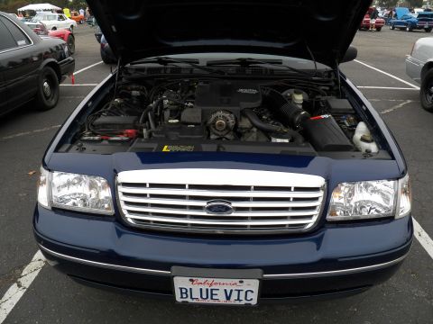 2003 Ford Crown Victoria - Open-hood shot of a Ford Crown Victoria showing V8 engine and chrome grille, California BLUE VIC plate.
