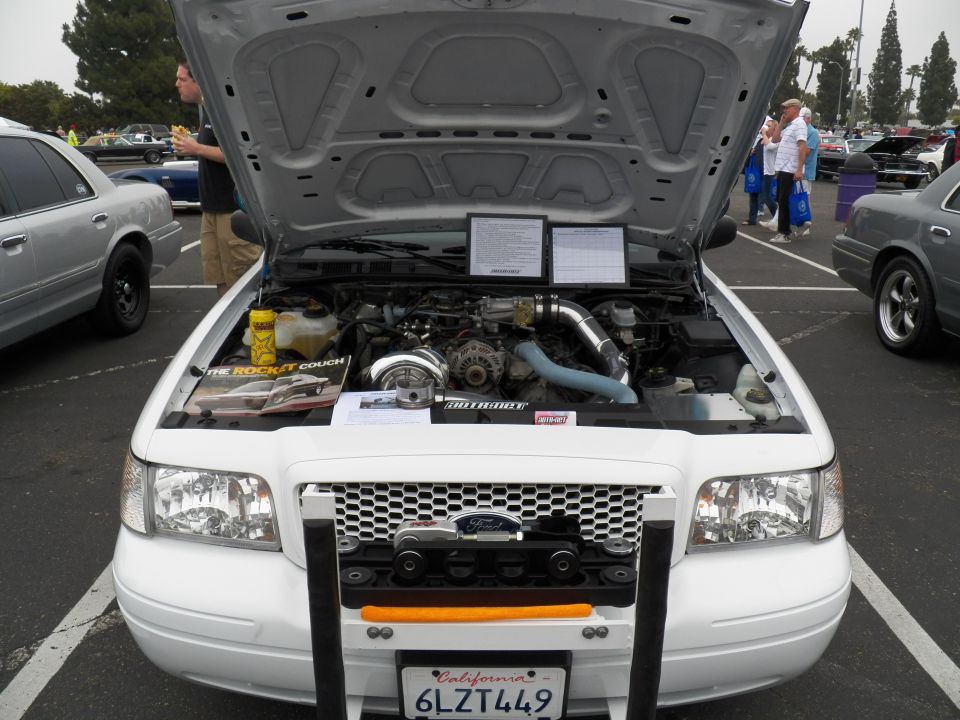 White Ford Crown Victoria engine bay with Motorvac display, 6LZT449 California plate