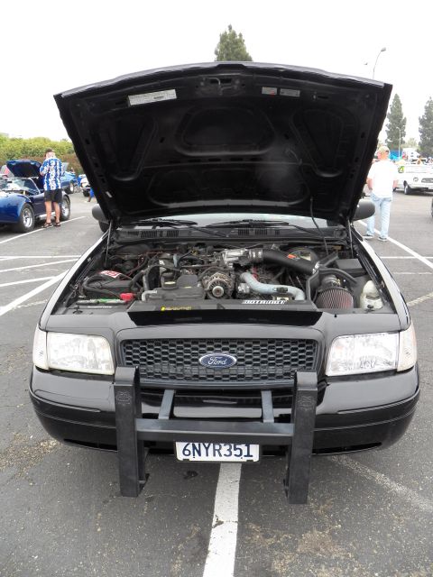 2003 Ford Crown Victoria - Vertical front shot of black Crown Victoria with cold-air intake and California 6NYR351 plate.