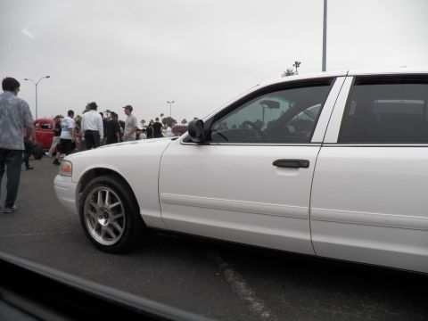 2003 Ford Crown Victoria - Side view of a lowered white Crown Victoria with tinted windows and crowd in the background.
