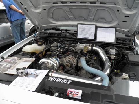 2003 Ford Crown Victoria - Open engine bay showing a centrifugal supercharger, polished intake tube and AutoRnet display placards.