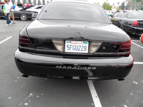 2003 Ford Crown Victoria - Rear view of a black Mercury Marauder showing its badge and California plate 5FGU228 in a show lot.