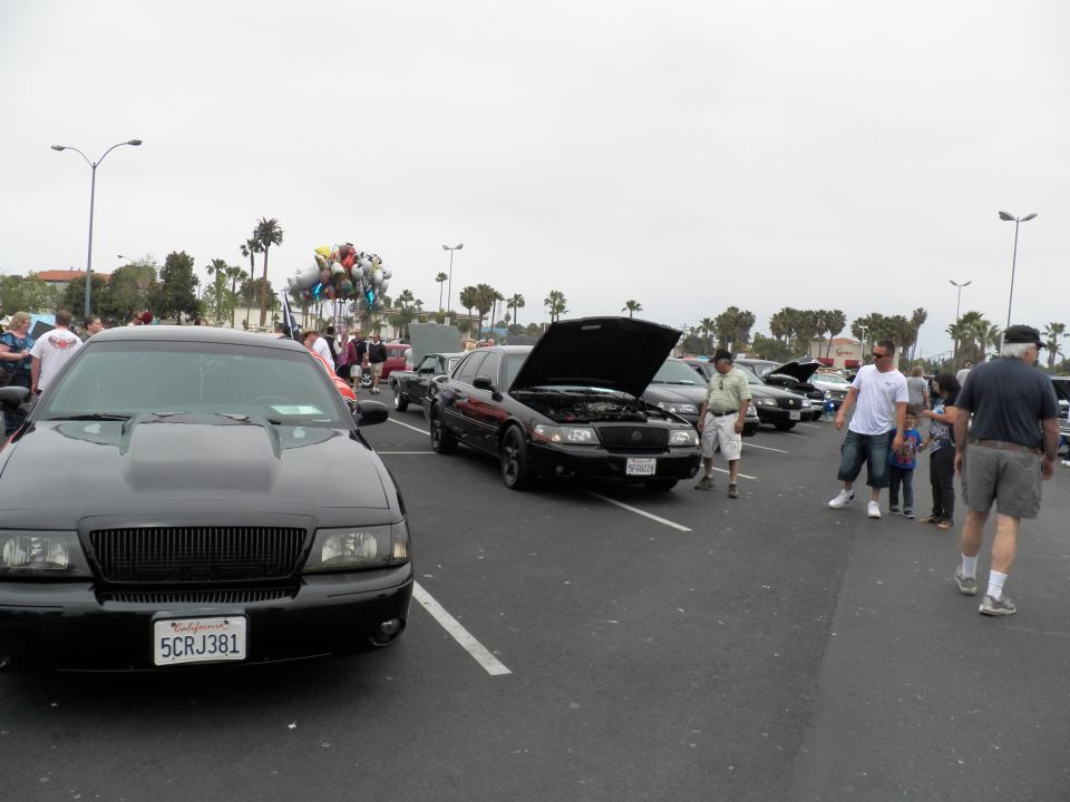 Black Mercury sedan with hood scoop and plate 5CRJ381 in car show lot
