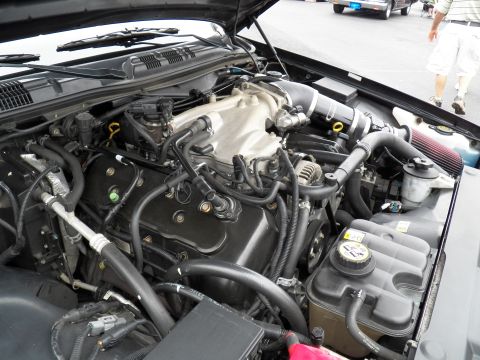 2003 Ford Crown Victoria - Top-down look at a V8 engine compartment with plastic intake manifold and aftermarket air filter